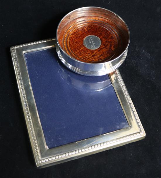 A silver mounted photograph frame and a silver coaster.